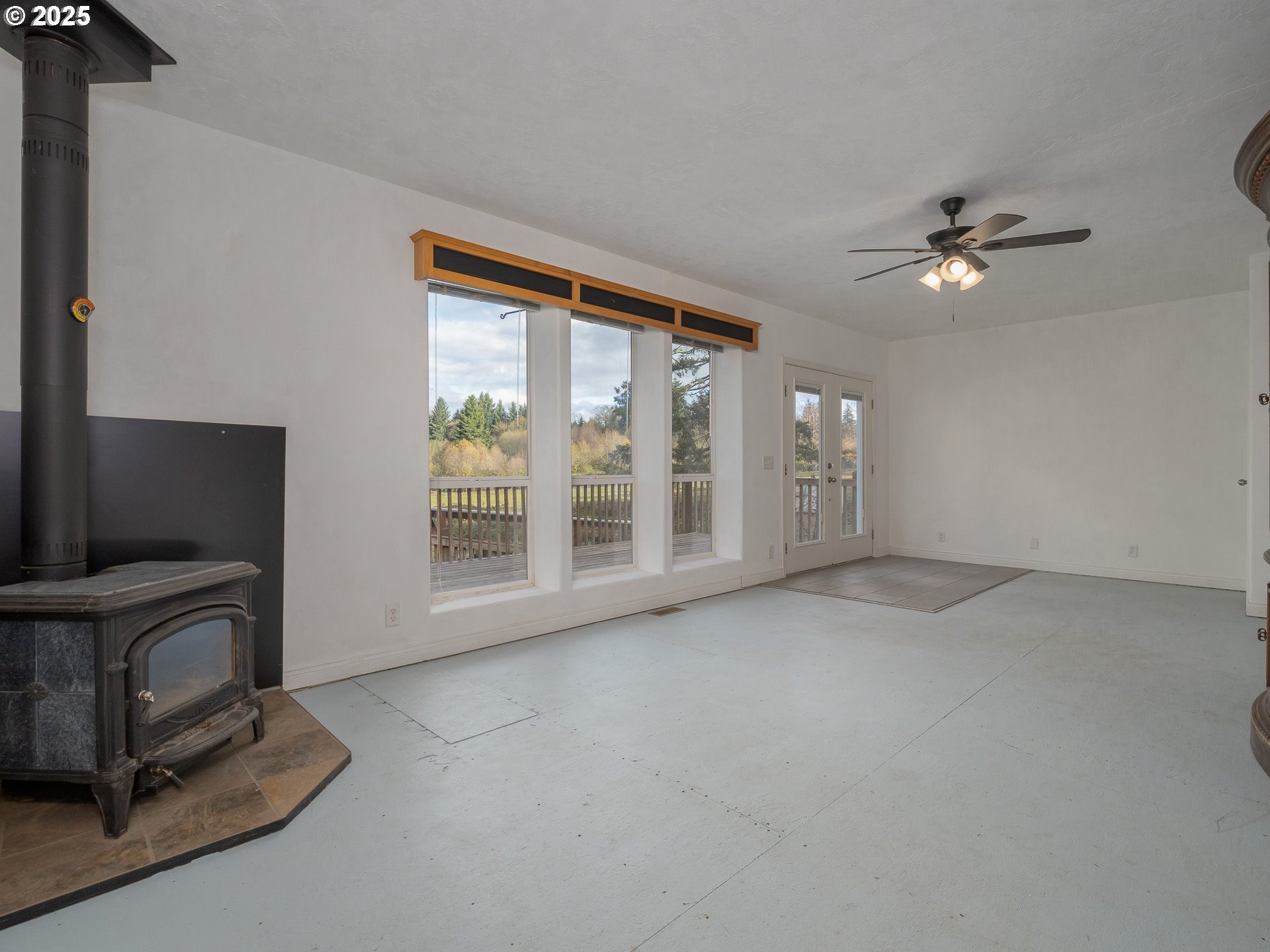 44300 Southeast Sandercock Lane Sandy, OR 97055 - Photo 20 of 48 an empty room with chandelier fan and windows