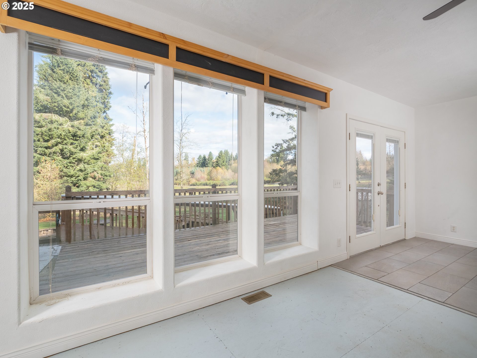 44300 Southeast Sandercock Lane Sandy, OR 97055 - Photo 23 of 48 a view of an empty room with wooden floor and a window