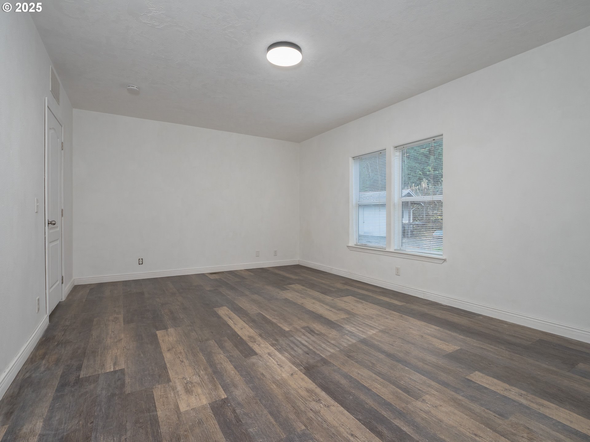 44300 Southeast Sandercock Lane Sandy, OR 97055 - Photo 33 of 48 an empty room with wooden floor and windows