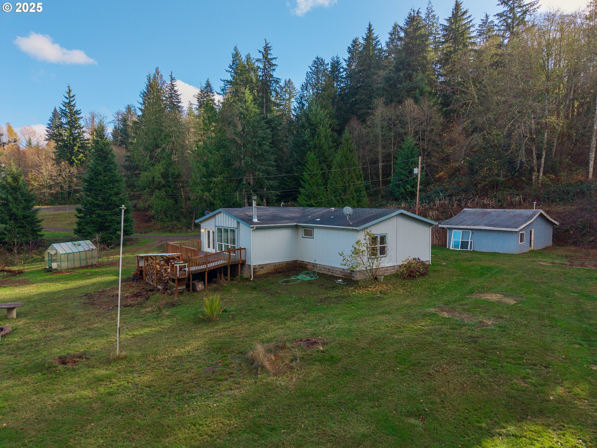 44300 Southeast Sandercock Lane Sandy, OR 97055 - Photo 35 of 48 a backyard of a house with table and chairs