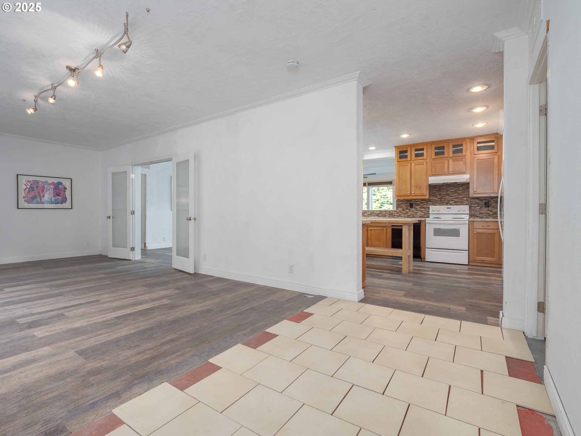 44300 Southeast Sandercock Lane Sandy, OR 97055 - Photo 9 of 48 a view of a hallway with wooden floor and a refrigerator