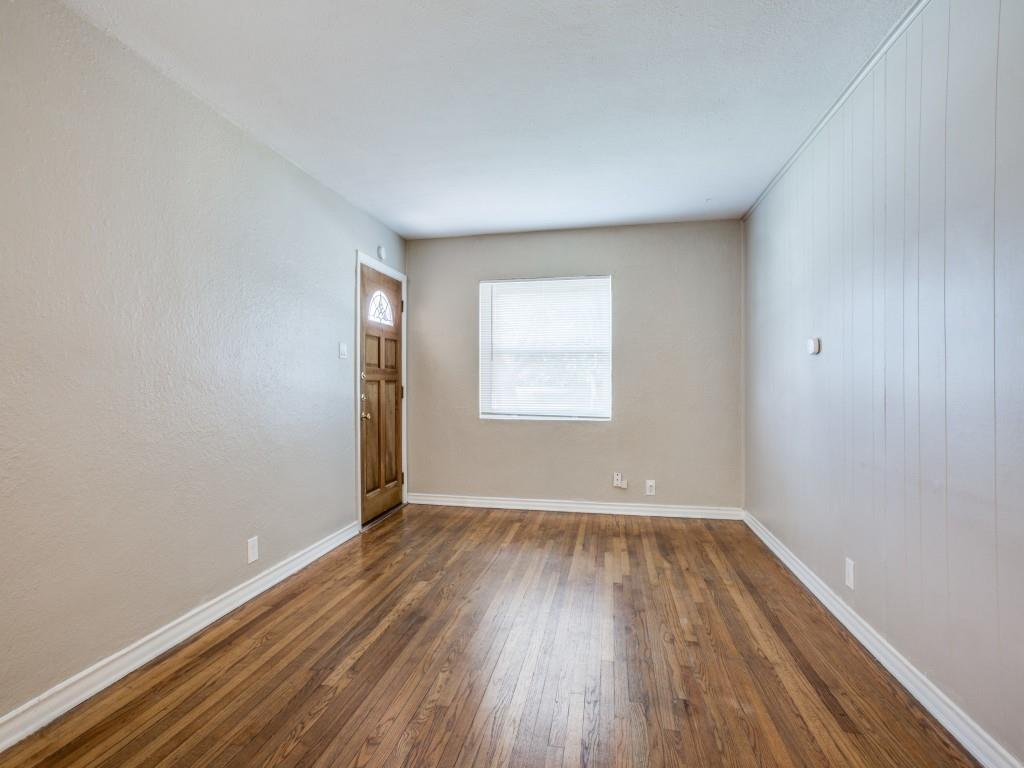 902 Denton Street Denton, TX 76201 - Photo 2 of 11 Bright living room featuring beautiful, original hardwood floors.