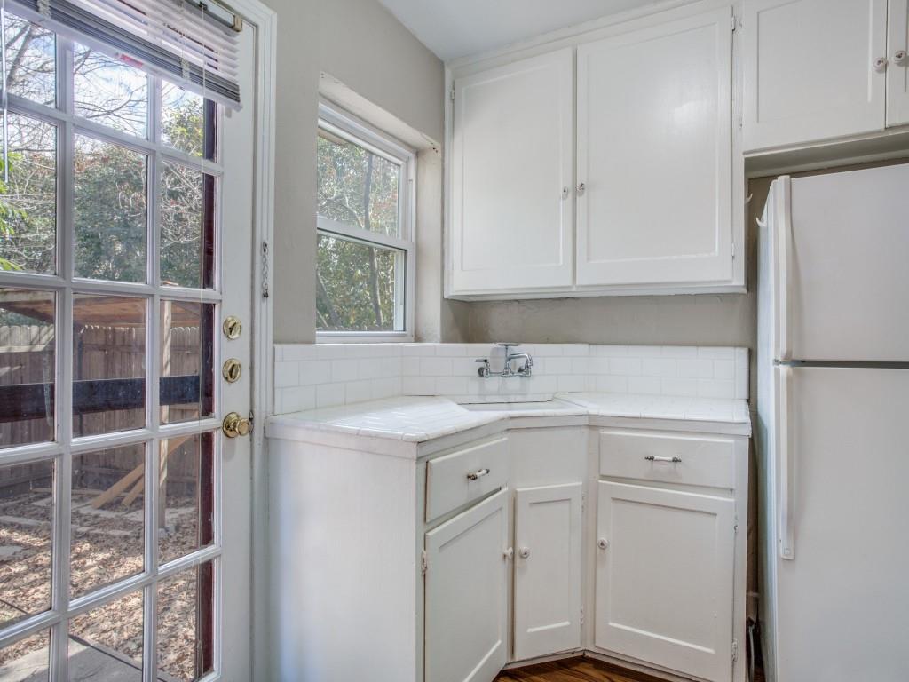 902 Denton Street Denton, TX 76201 - Photo 6 of 11 Light-filled workspace with a glass door leading to the backyard.