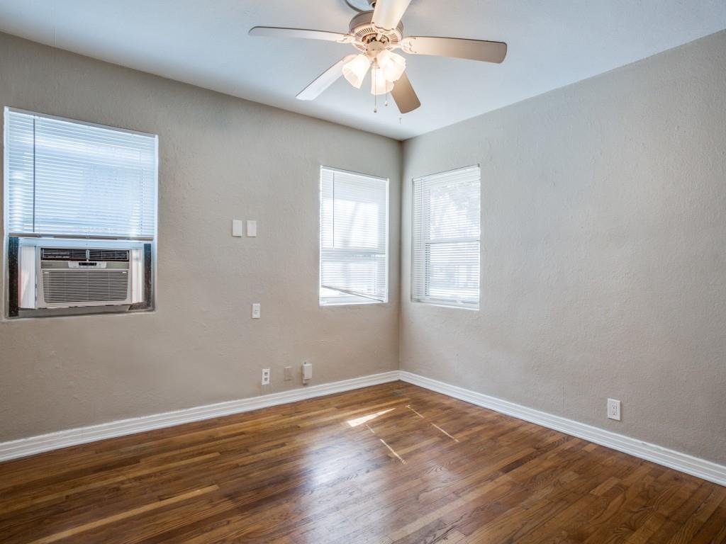 902 Denton Street Denton, TX 76201 - Photo 7 of 11 Spacious secondary bedroom with large windows and neutral paint.