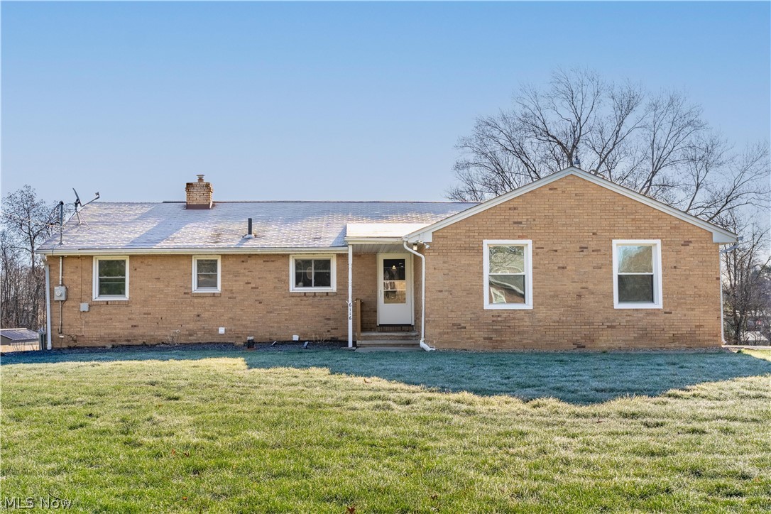 6116 Melody Road Northeast Canton, OH 44721 - Photo 1 of 33 Rear view of house with brick siding, a yard, and a chimney