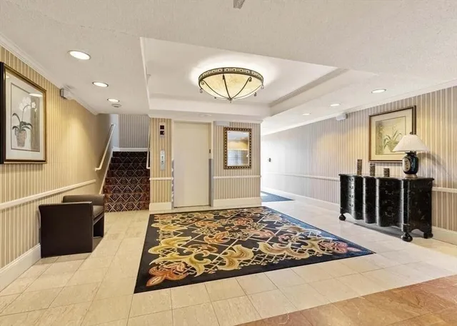 a living room with large rug and a rug