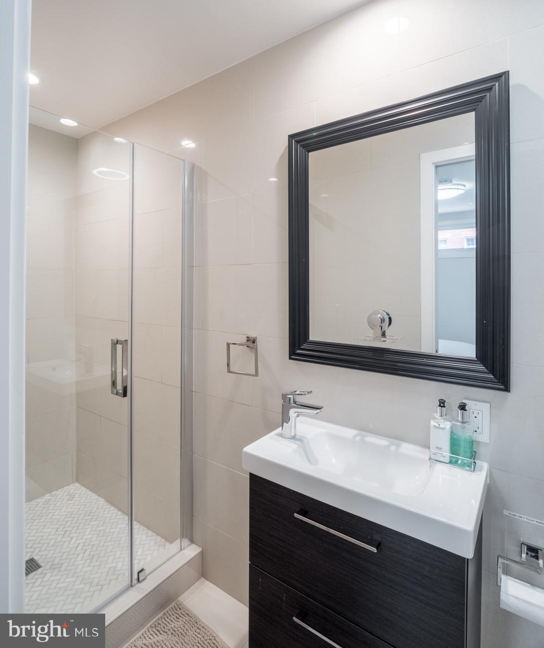 3500 P Street Northwest Washington, DC 20007 - Photo 4 of 15 a bathroom with a sink a light fixture and a mirror