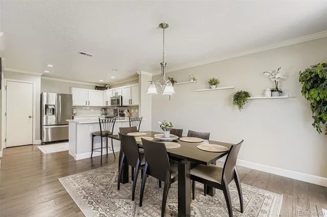 a dining room with furniture and wooden floor