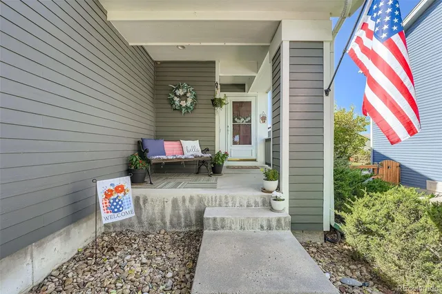 a street with a large window and potted plants