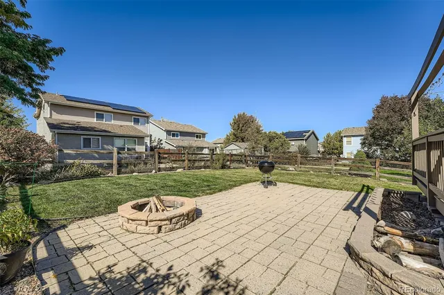 a view of a backyard with sitting area