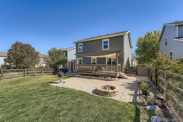 a view of a house with backyard and sitting area