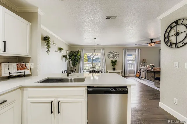 a kitchen with a table chairs and white cabinets