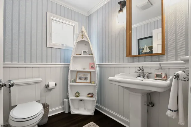 a bathroom with a sink toilet and mirror