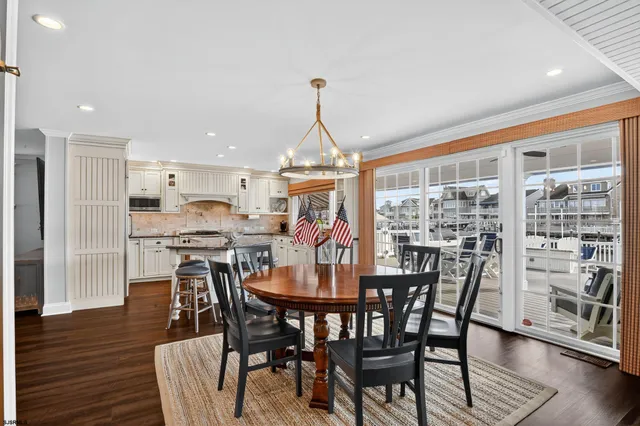 a dining room with furniture window and wooden floor