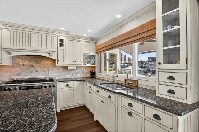 a kitchen with granite countertop a sink and a stove