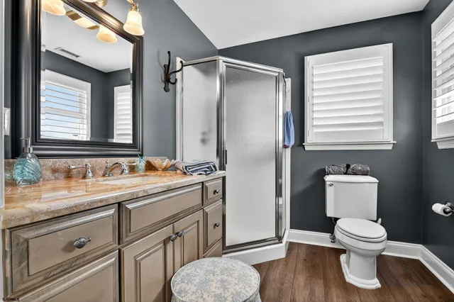 a bathroom with a sink toilet and shower
