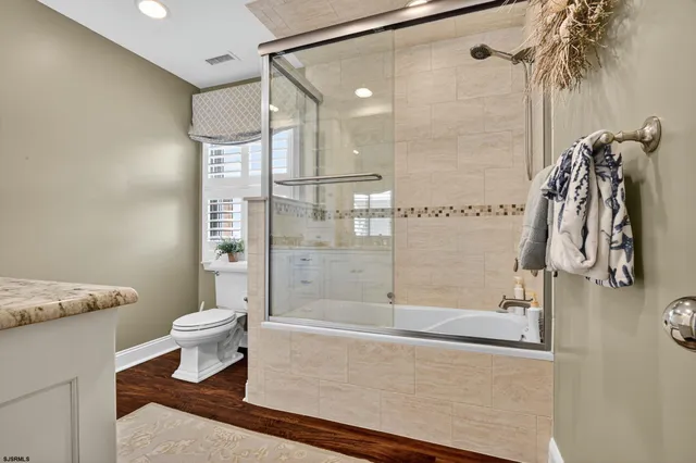 a bathroom with a shower and a toilet