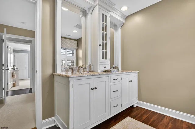 a bathroom with a double vanity sink and a mirror