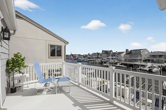 a view of a balcony with wooden chairs