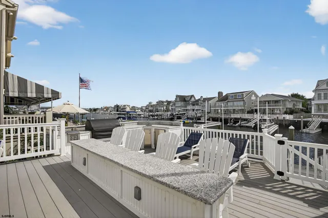 a view of a balcony with wooden floor and seating space