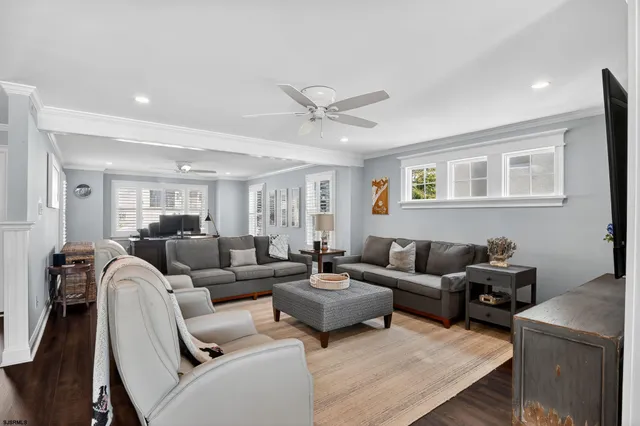 a living room with furniture and a ceiling fan