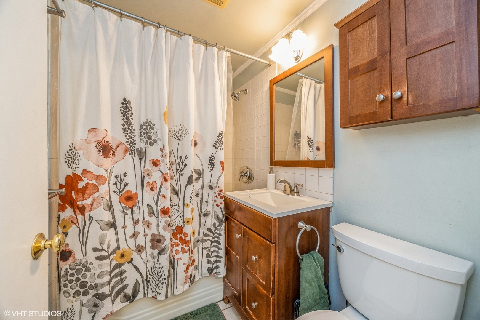 9542 Monroe Avenue Brookfield, IL 60513 - Photo 16 of 21 a bathroom with a sink a toilet and shower curtain