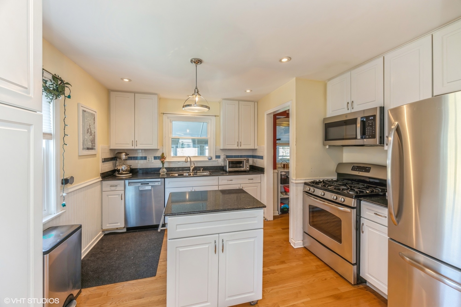 9542 Monroe Avenue Brookfield, IL 60513 - Photo 7 of 21 a kitchen with granite countertop a refrigerator stove and kitchen island