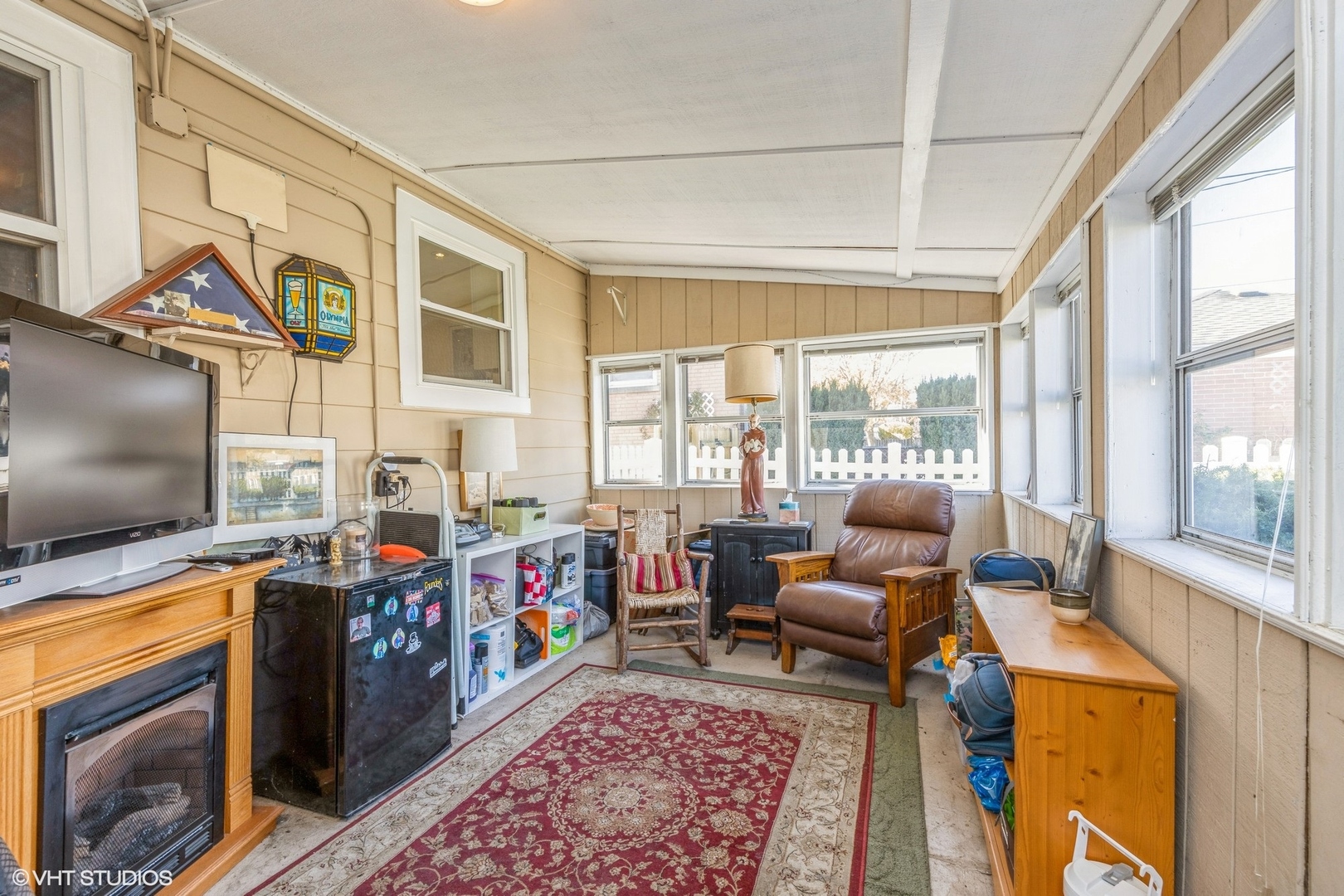 9542 Monroe Avenue Brookfield, IL 60513 - Photo 10 of 21 a living room with furniture a flat screen tv and a floor to ceiling window