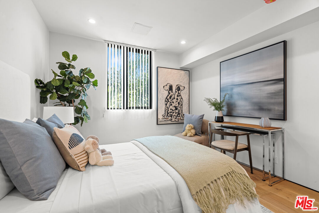 11706 Charnock Road Los Angeles, CA 90066 - Photo 13 of 32 a bedroom with a bed and a potted plant