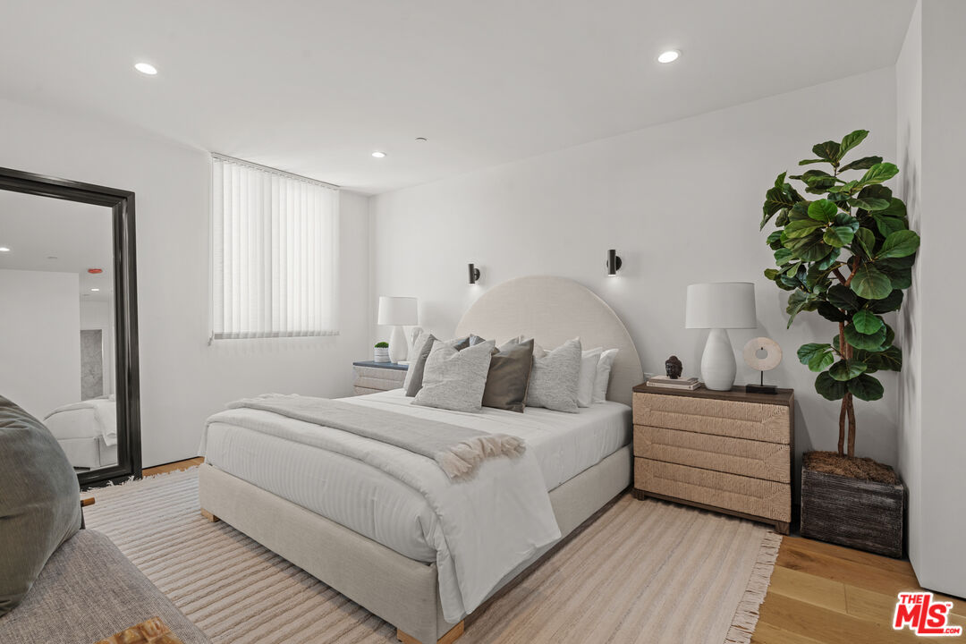 11706 Charnock Road Los Angeles, CA 90066 - Photo 15 of 32 a bedroom with a bed and a potted plant