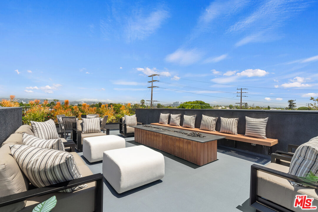11706 Charnock Road Los Angeles, CA 90066 - Photo 26 of 32 a balcony with furniture and city view