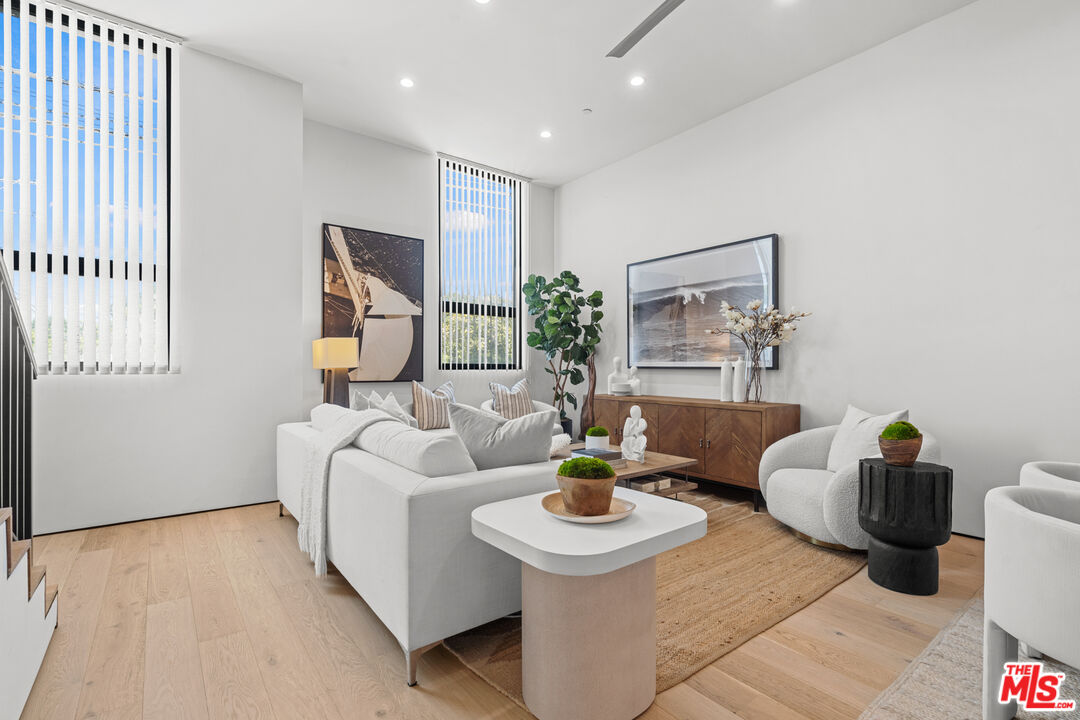 11706 Charnock Road Los Angeles, CA 90066 - Photo 3 of 32 a living room with furniture and a potted plant