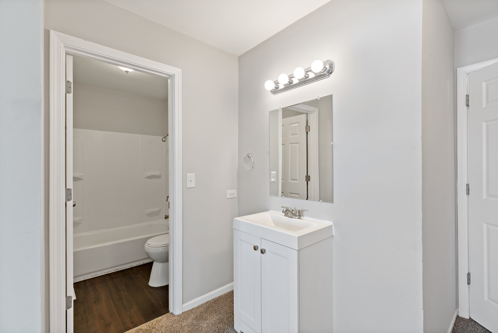 58 Cloverleaf Road Matteson, IL 60443 - Photo 12 of 19 a bathroom with a sink a toilet and a mirror