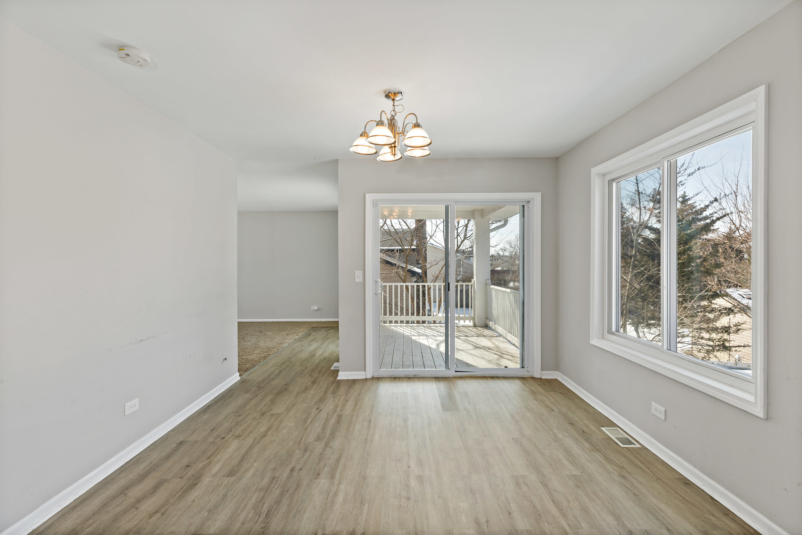 58 Cloverleaf Road Matteson, IL 60443 - Photo 5 of 19 a view of an empty room with wooden floor and a window