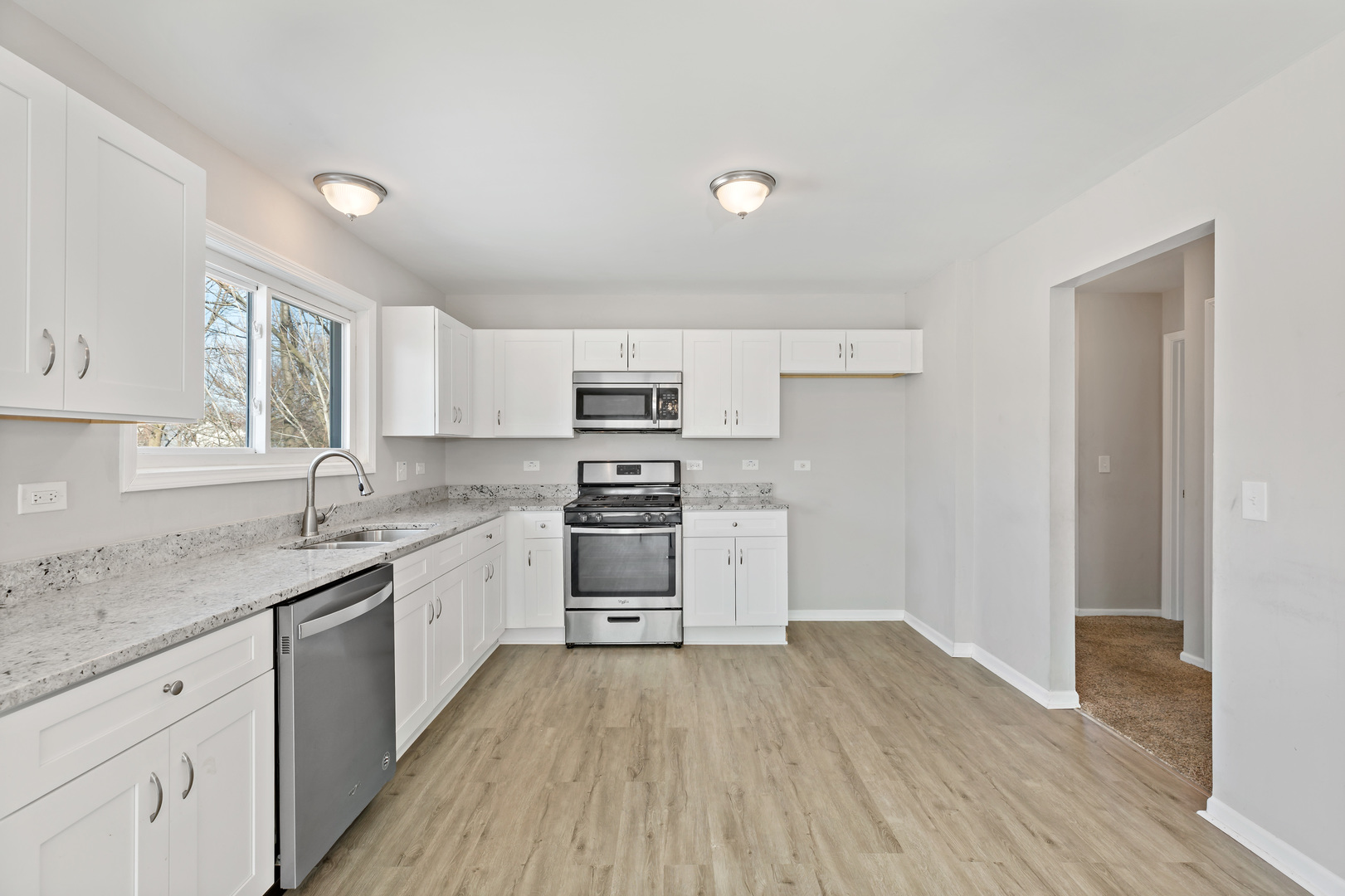 58 Cloverleaf Road Matteson, IL 60443 - Photo 6 of 19 a kitchen with granite countertop a sink cabinets and stainless steel appliances