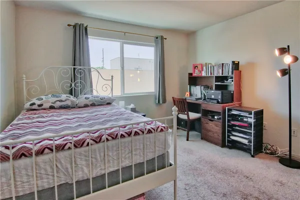 a bedroom with a bed closet and a window