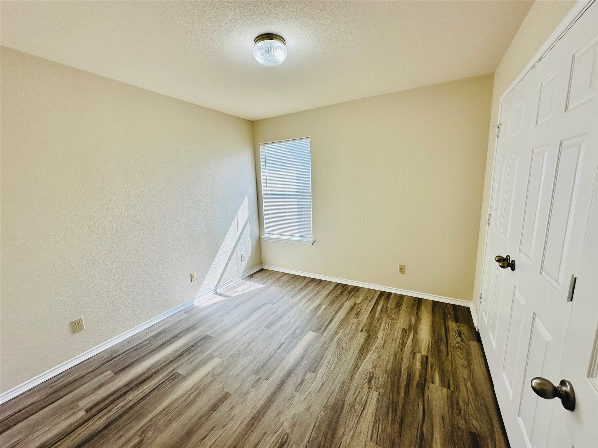 8814 Schick Road, Unit C Austin, TX 78729 - Photo 26 of 35 Sun-filled room boasts resilient wood-look flooring and ample space for rest or productivity.