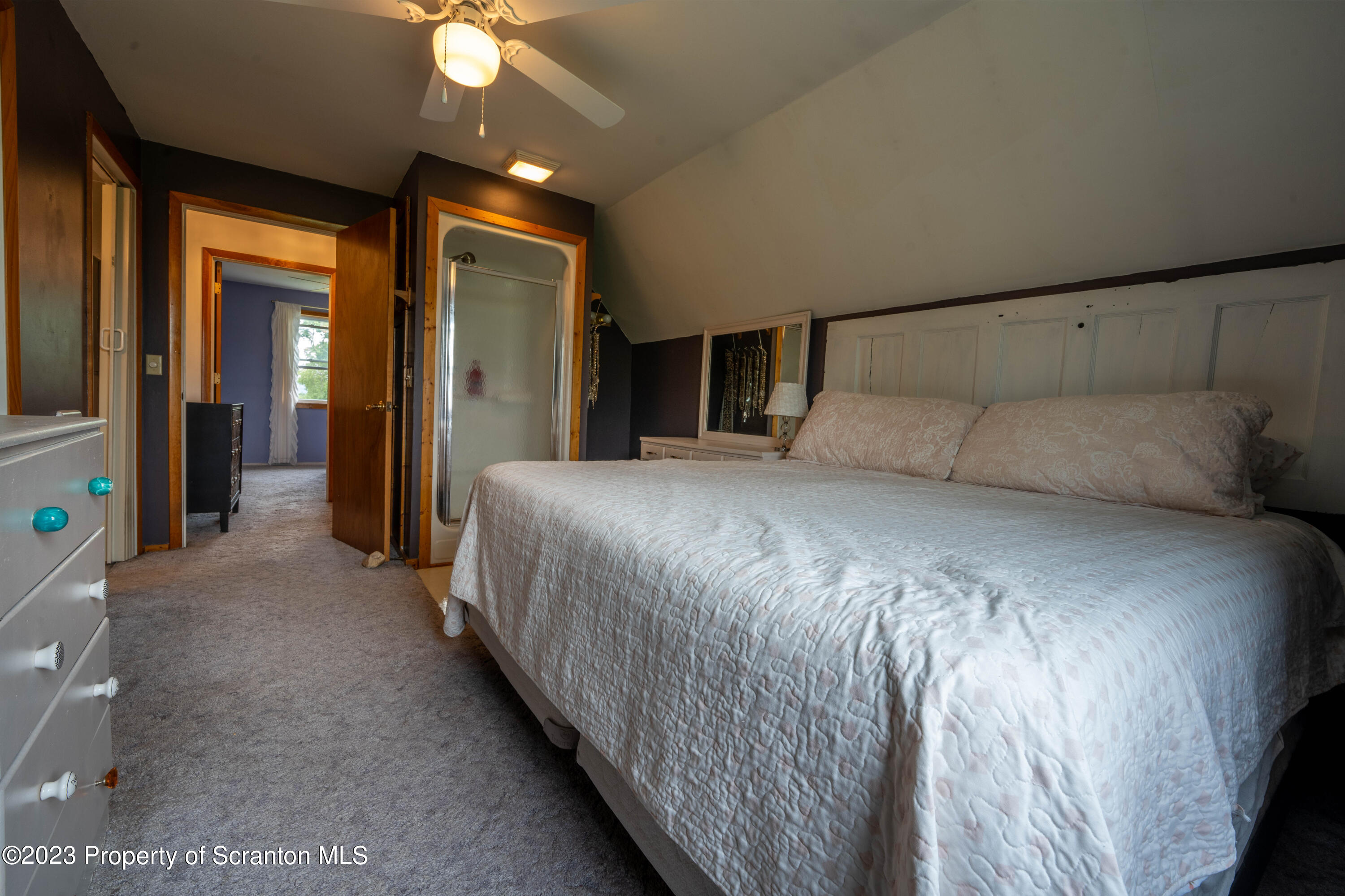 2759 State Rte 3011 Meshoppen, PA 18630 - Photo 12 of 30 a bedroom with a large bed and a chandelier