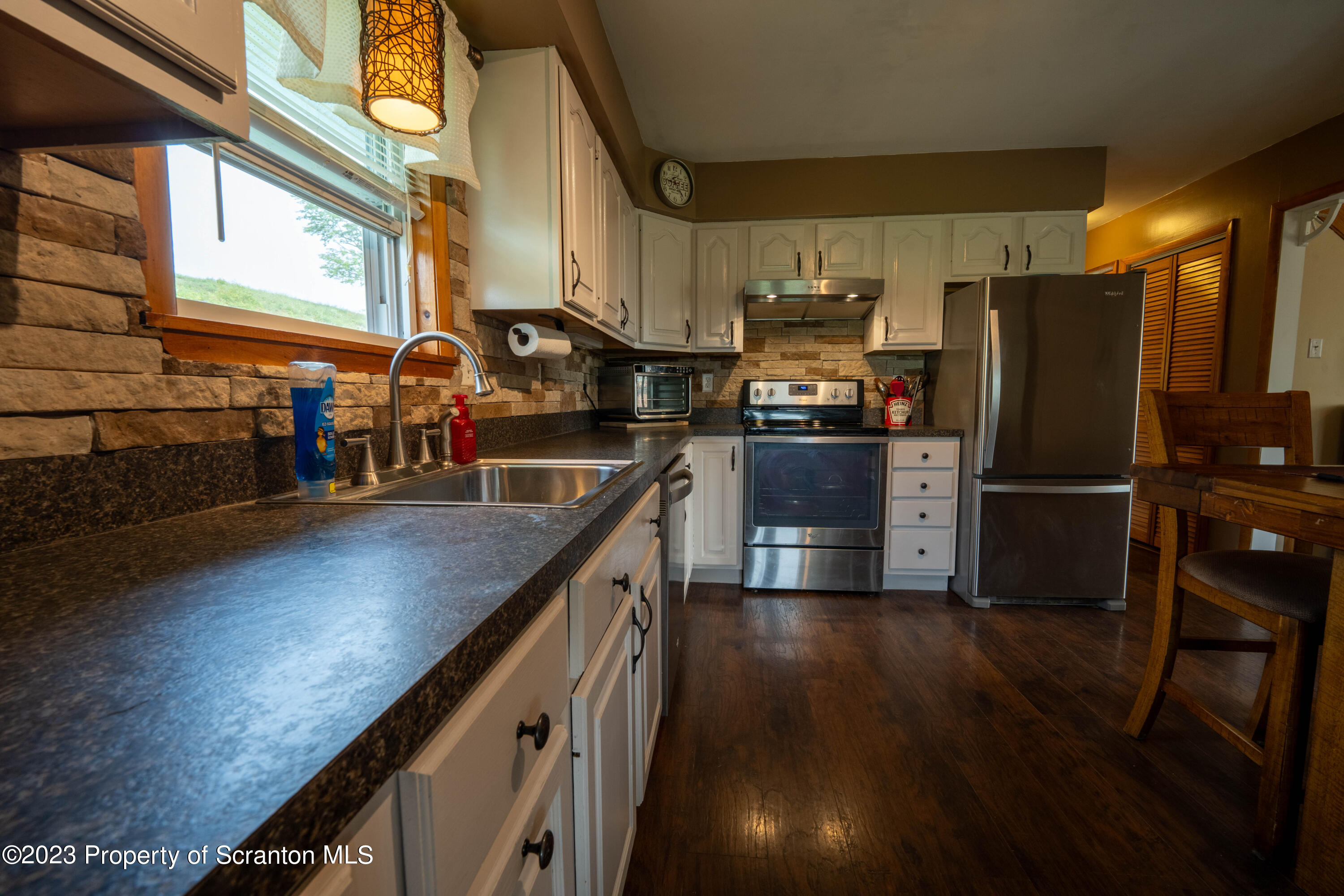 2759 State Rte 3011 Meshoppen, PA 18630 - Photo 4 of 30 a kitchen with stainless steel appliances granite countertop a sink a stove and a refrigerator
