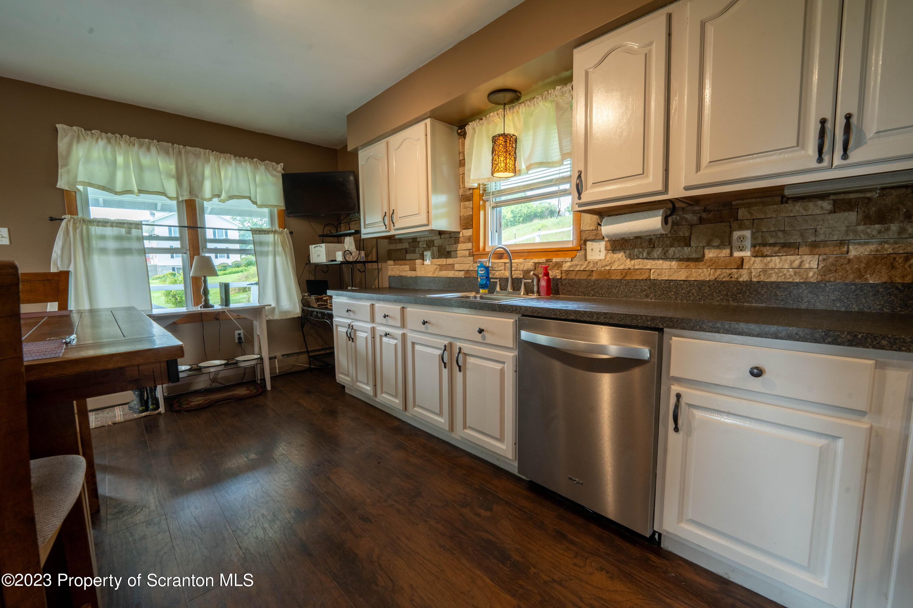 2759 State Rte 3011 Meshoppen, PA 18630 - Photo 5 of 30 a kitchen with stainless steel appliances granite countertop a stove a sink and a white cabinets