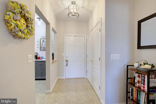 a view of a hallway to rooms and stairs