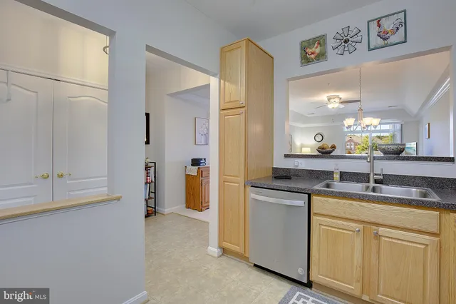 a kitchen with stainless steel appliances granite countertop a sink and a refrigerator
