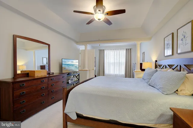 a bedroom with a large bed and a chandelier