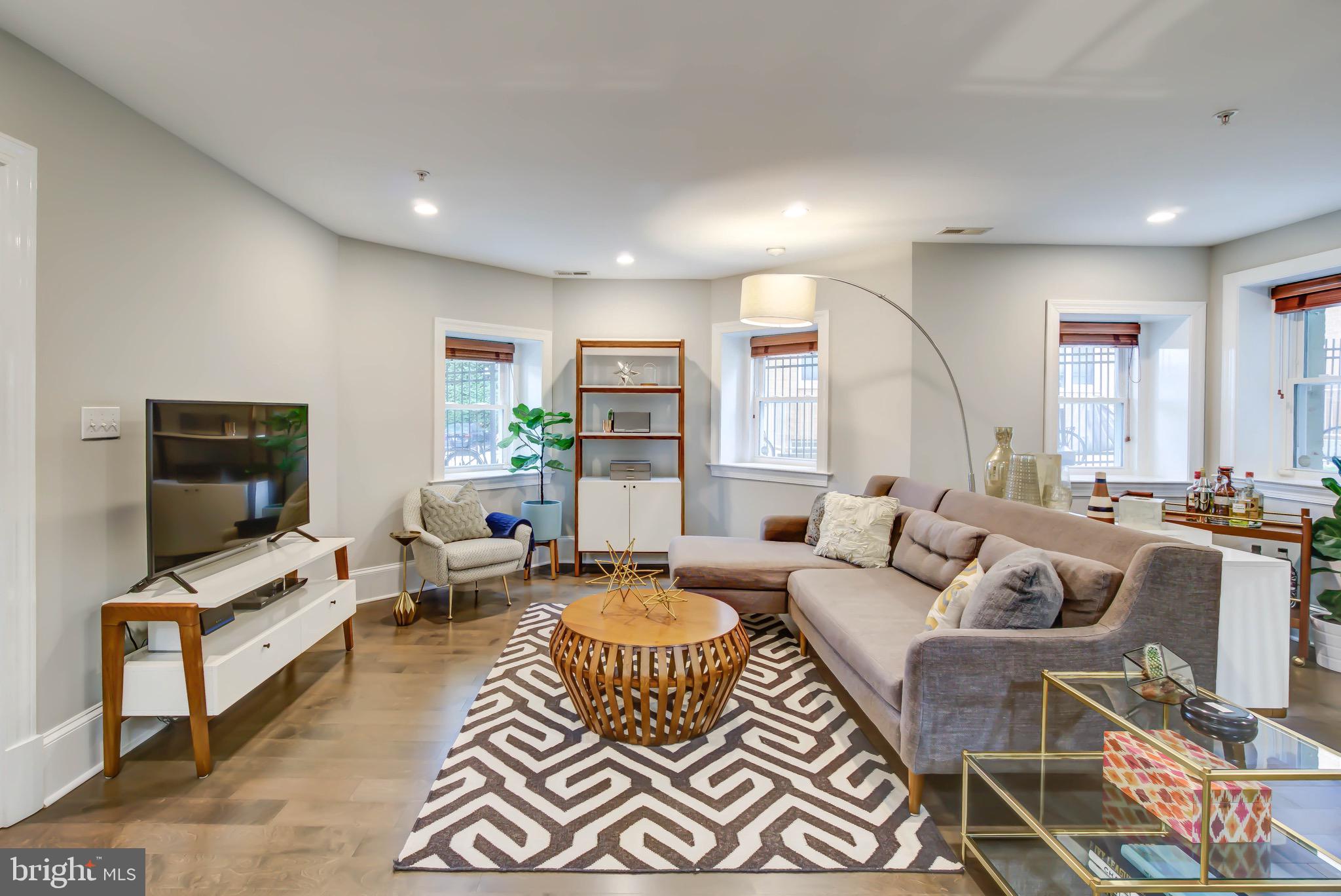 1324 Euclid Street Northwest, Unit 3 Washington, DC 20009 - Photo 2 of 23 a living room with furniture wooden floor and a flat screen tv