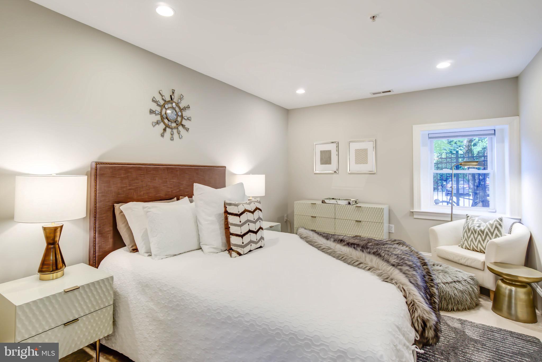 1324 Euclid Street Northwest, Unit 3 Washington, DC 20009 - Photo 13 of 23 a bedroom with a bed and wooden floor