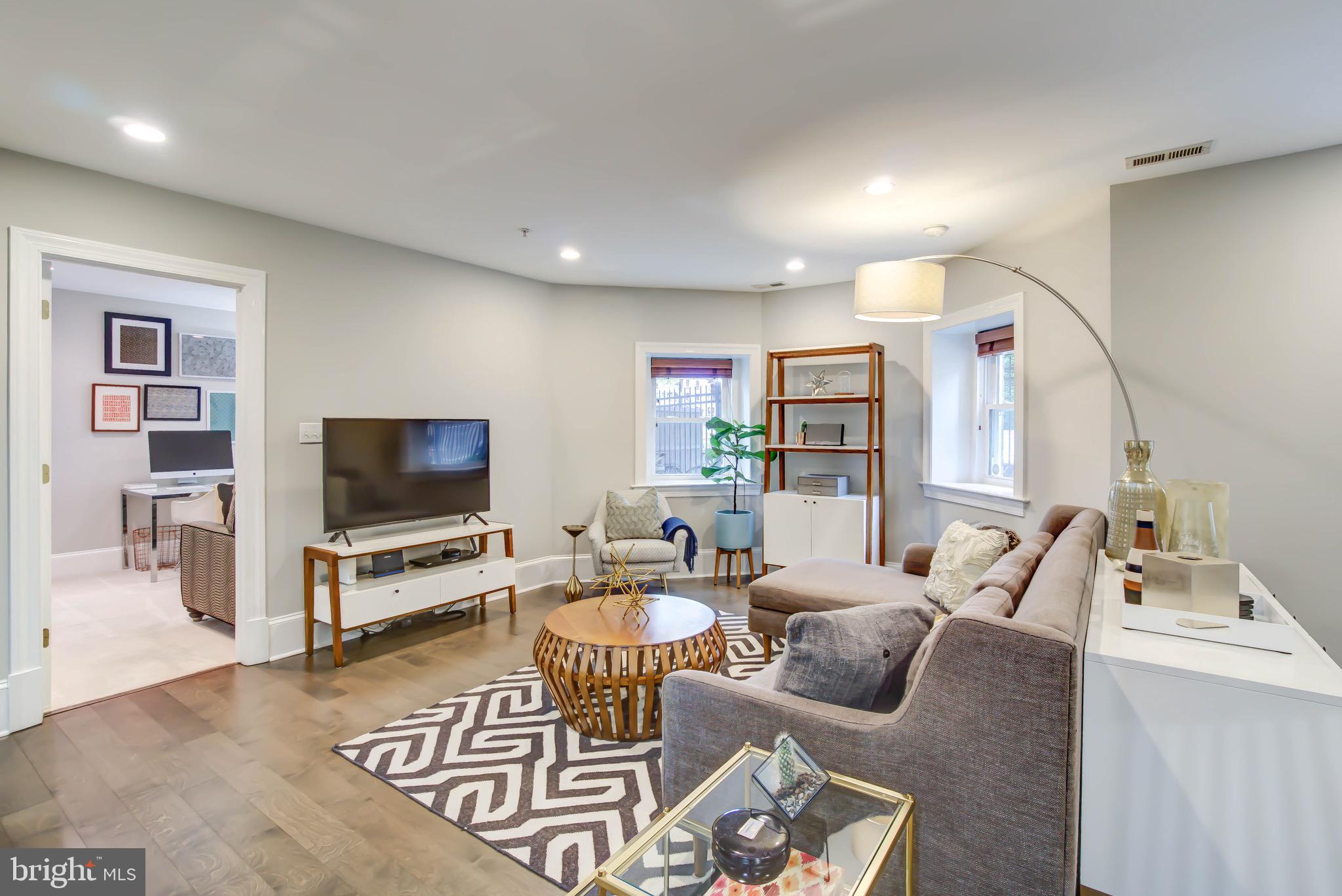 1324 Euclid Street Northwest, Unit 3 Washington, DC 20009 - Photo 3 of 23 a living room with furniture and a flat screen tv