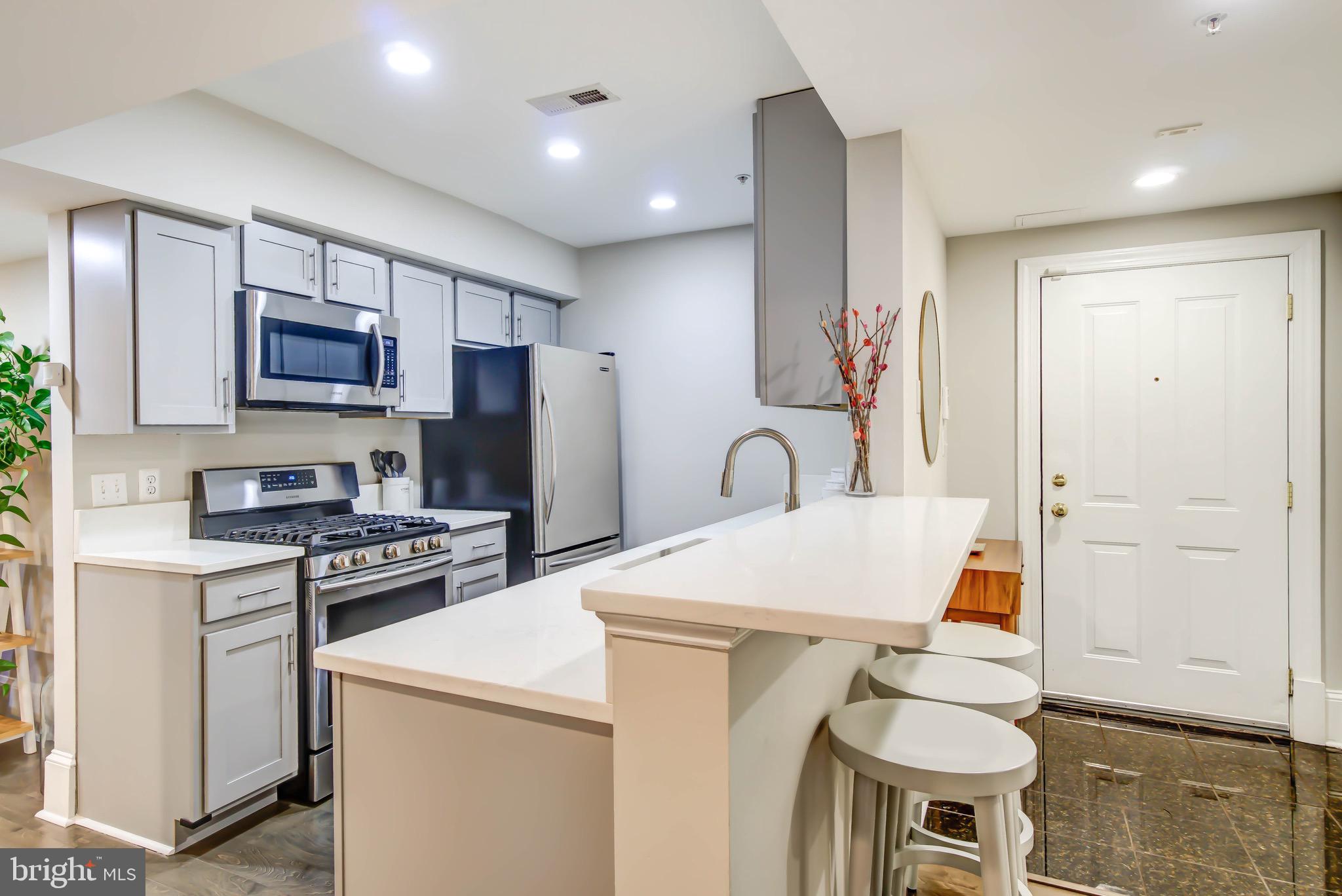 1324 Euclid Street Northwest, Unit 3 Washington, DC 20009 - Photo 5 of 23 a kitchen that has a sink cabinets and stainless steel appliances