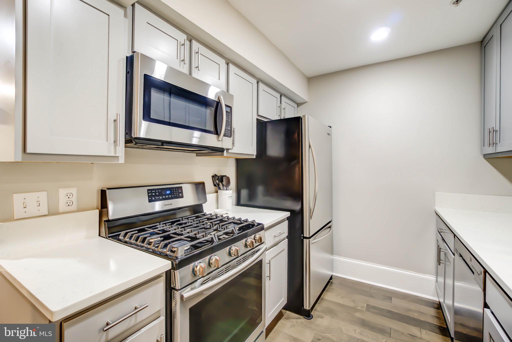 1324 Euclid Street Northwest, Unit 3 Washington, DC 20009 - Photo 8 of 23 a kitchen with stainless steel appliances granite countertop a stove and a refrigerator