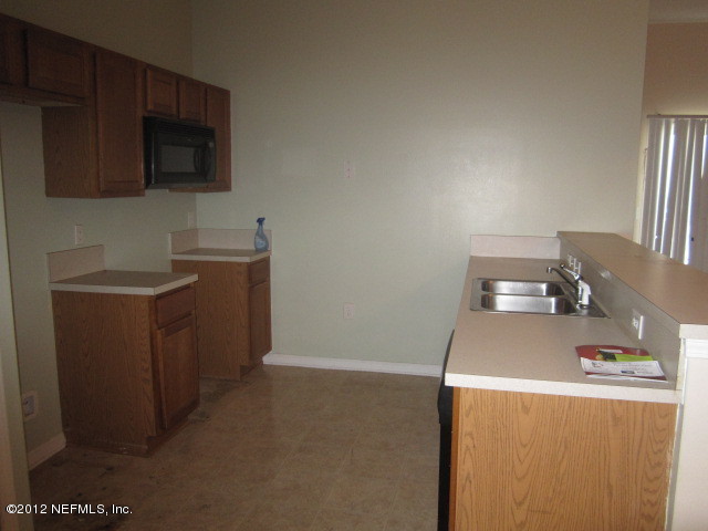 7920 Merrill Road, Unit 1003 Jacksonville, FL 32277 - Photo 5 of 9 a room with storage and utility