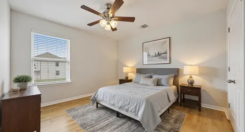 a bedroom with a large bed and a window